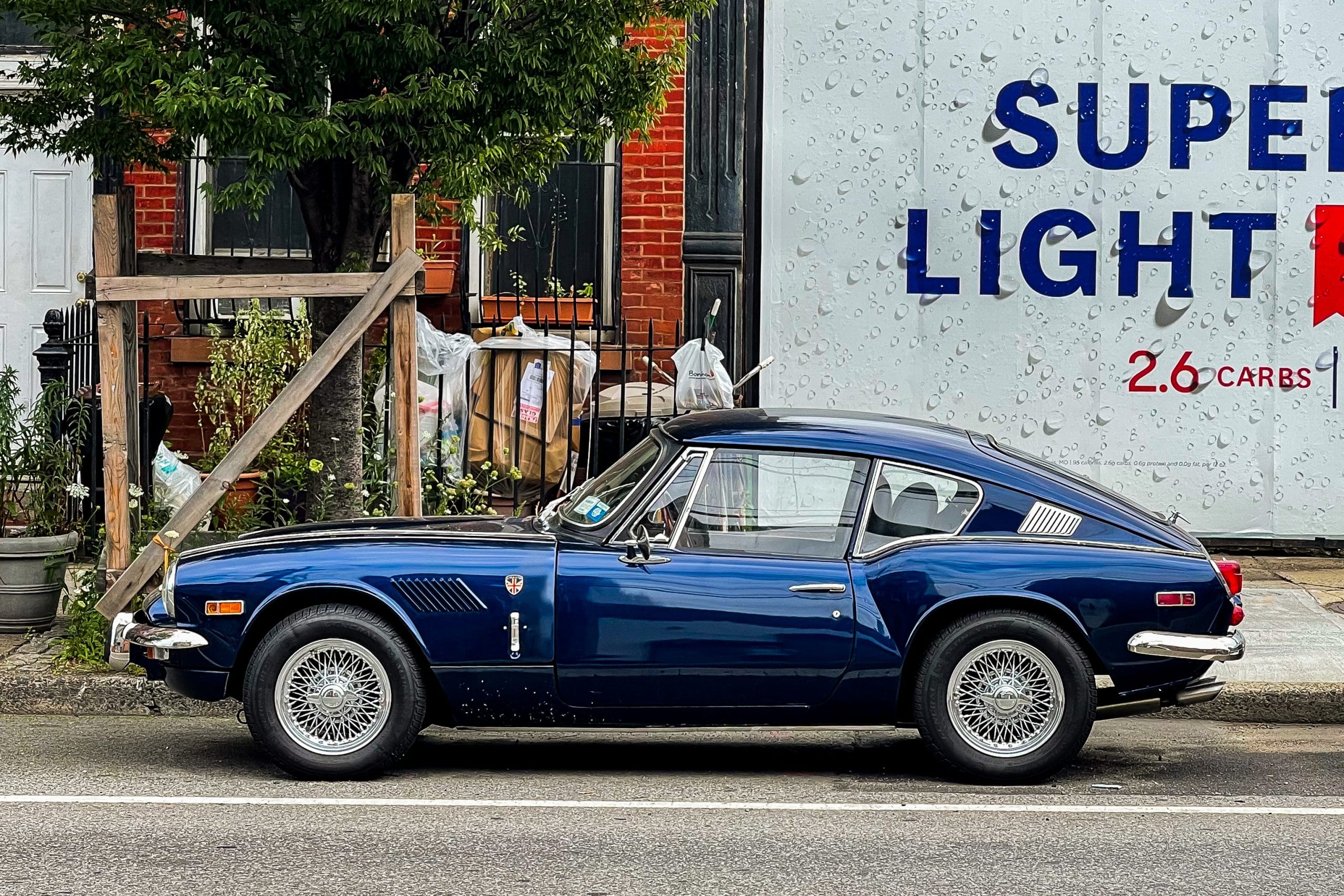 Photo of a vintage car in front of a billboard, by Dave Krugman
