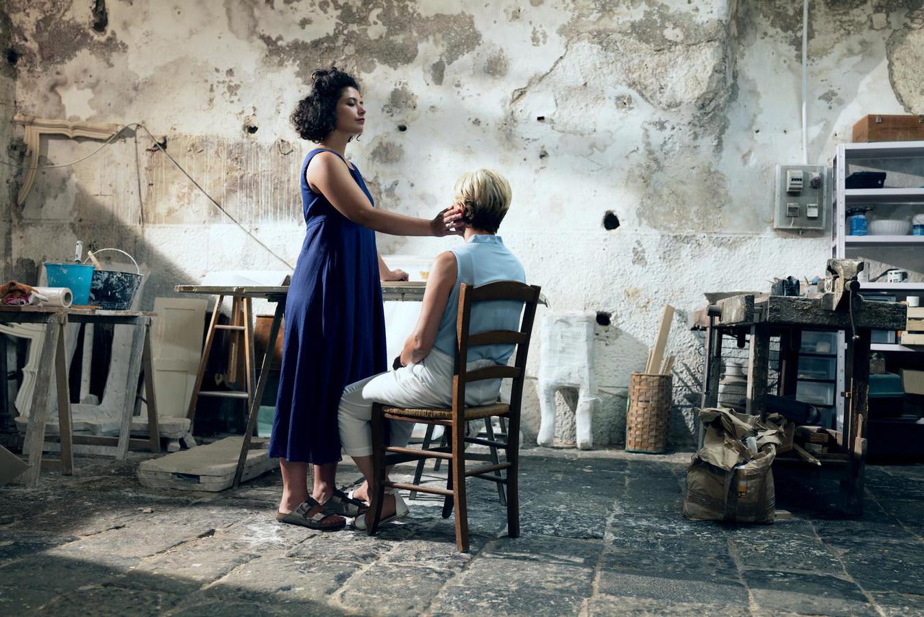 image of woman touching someones face as they sit in a chair. nivea nft