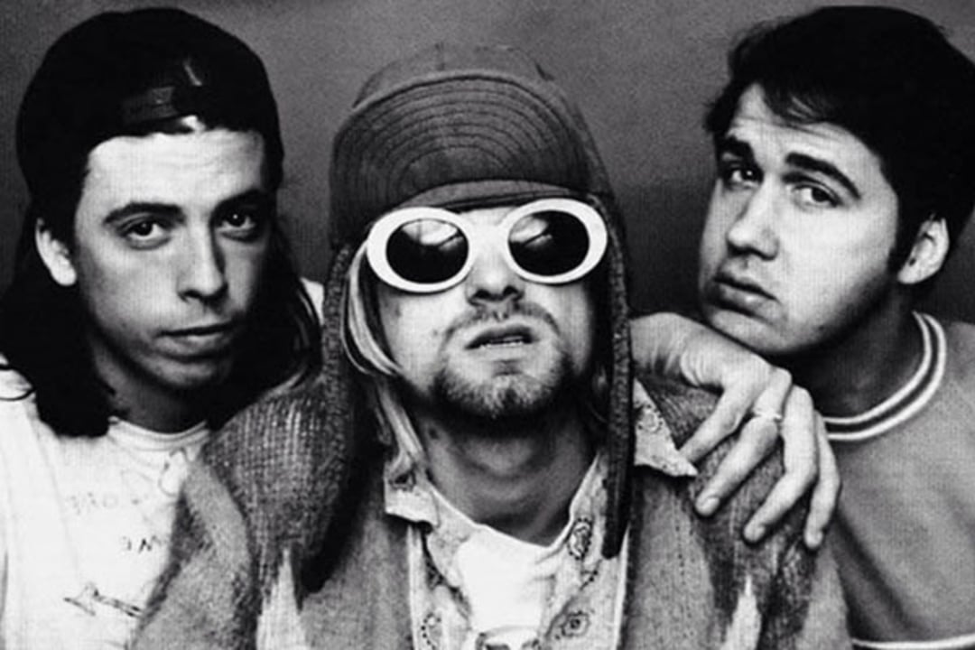 nirvana band in monochrome kurt cobai with sunglasses and a hat
