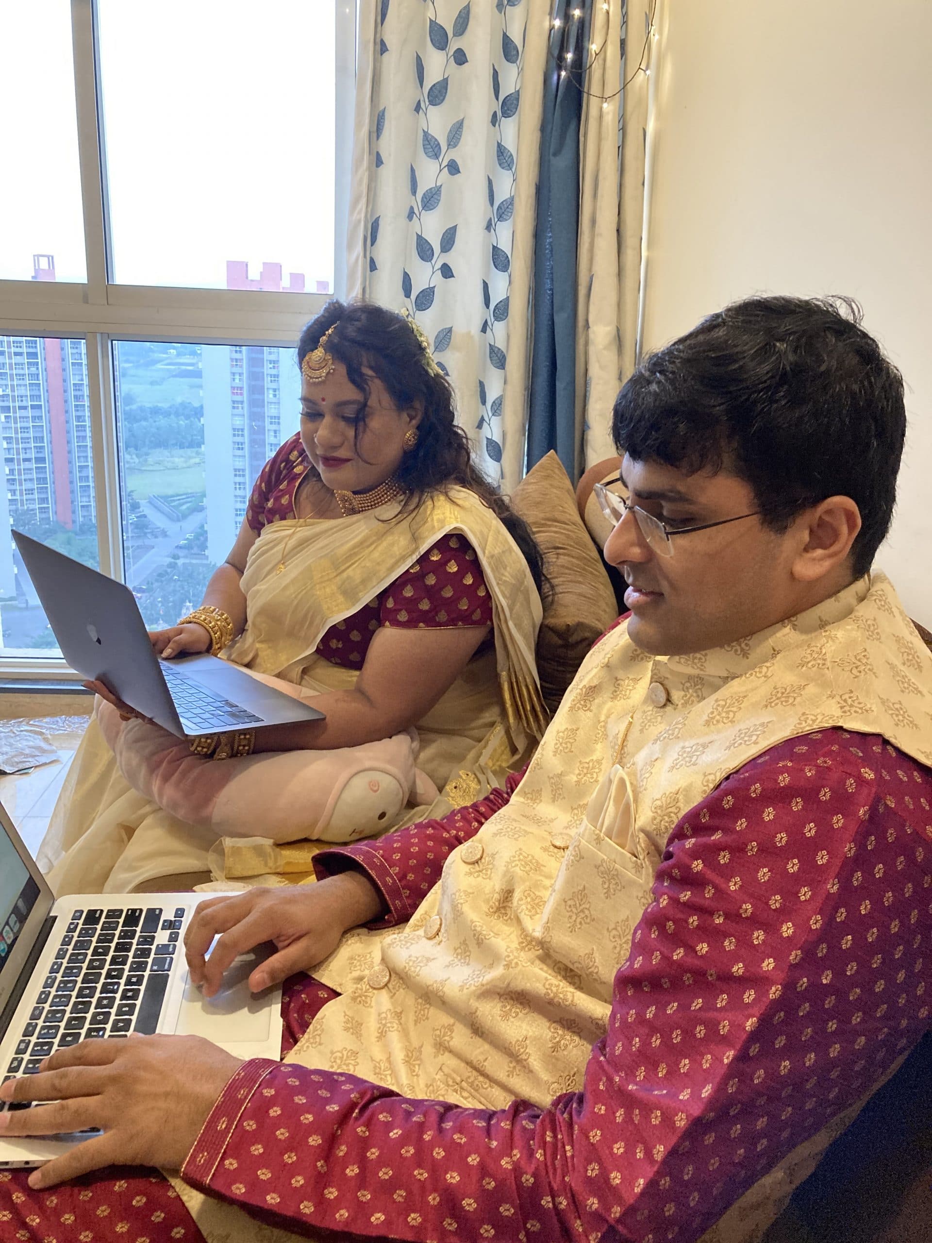 Pune couple seated in front of laptops during their blockchain wedding