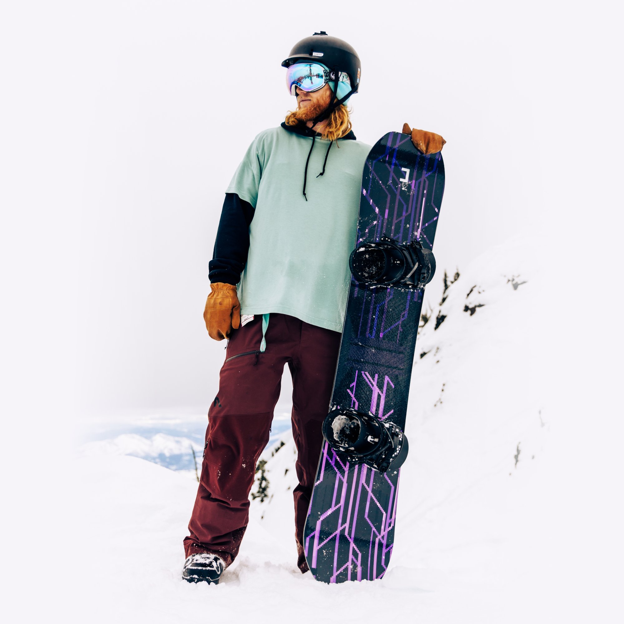 Image of a Jadu snowboard held by a snowboarder