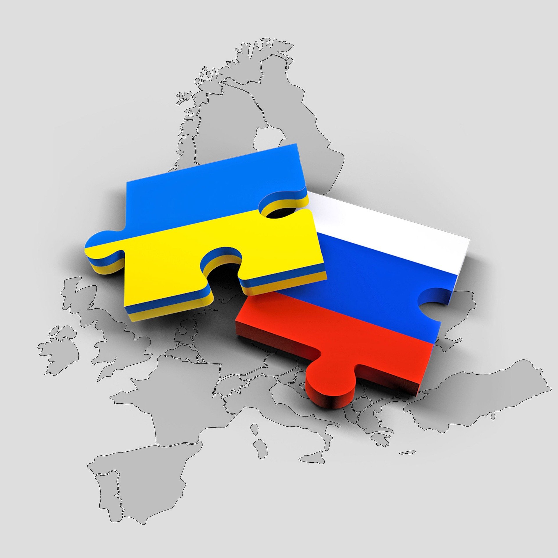 Puzzle pieces with Ukraine and Russian flags over a map