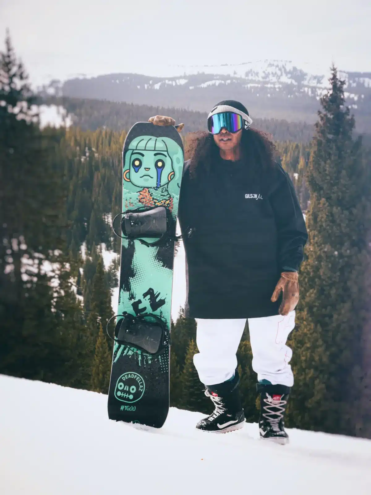 A person holding a Gilson ski with zombie artwork