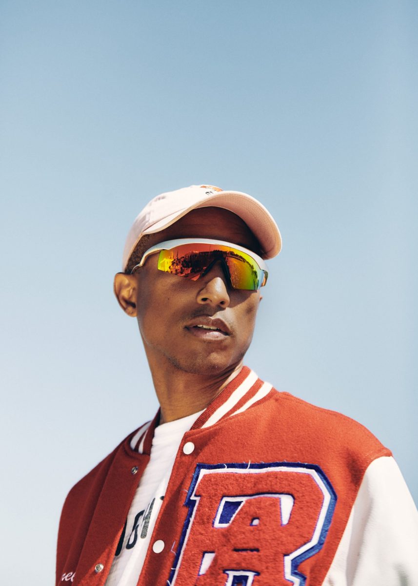 Pharell wearing a red varsity jacket