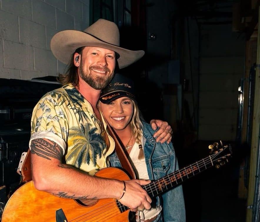 image of country performer Brian Kelley holding a guitar and his wife Brittney Kelley