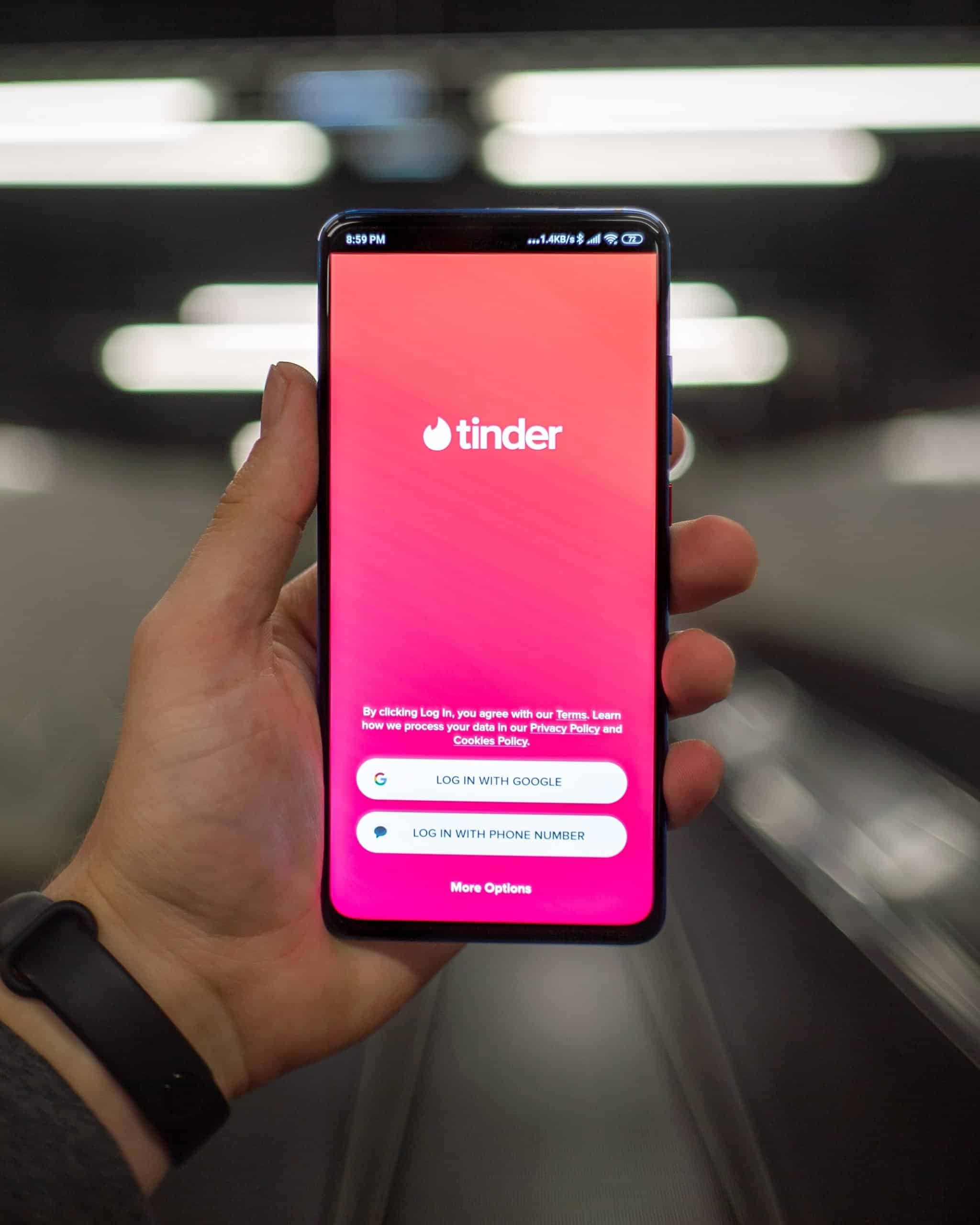 A phone showing the Tinder app
