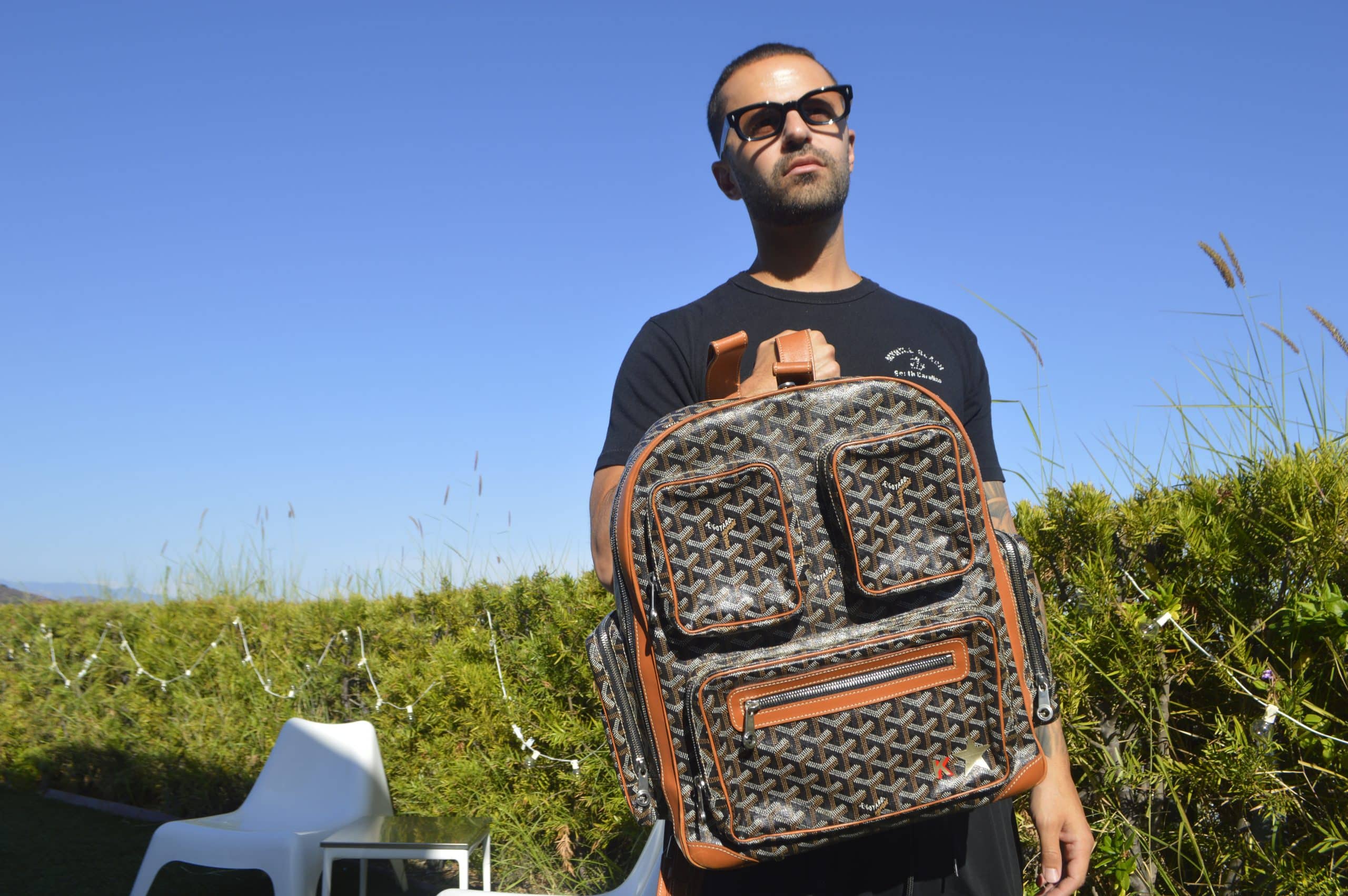 Image of man holding Goyard Kanye West backpack