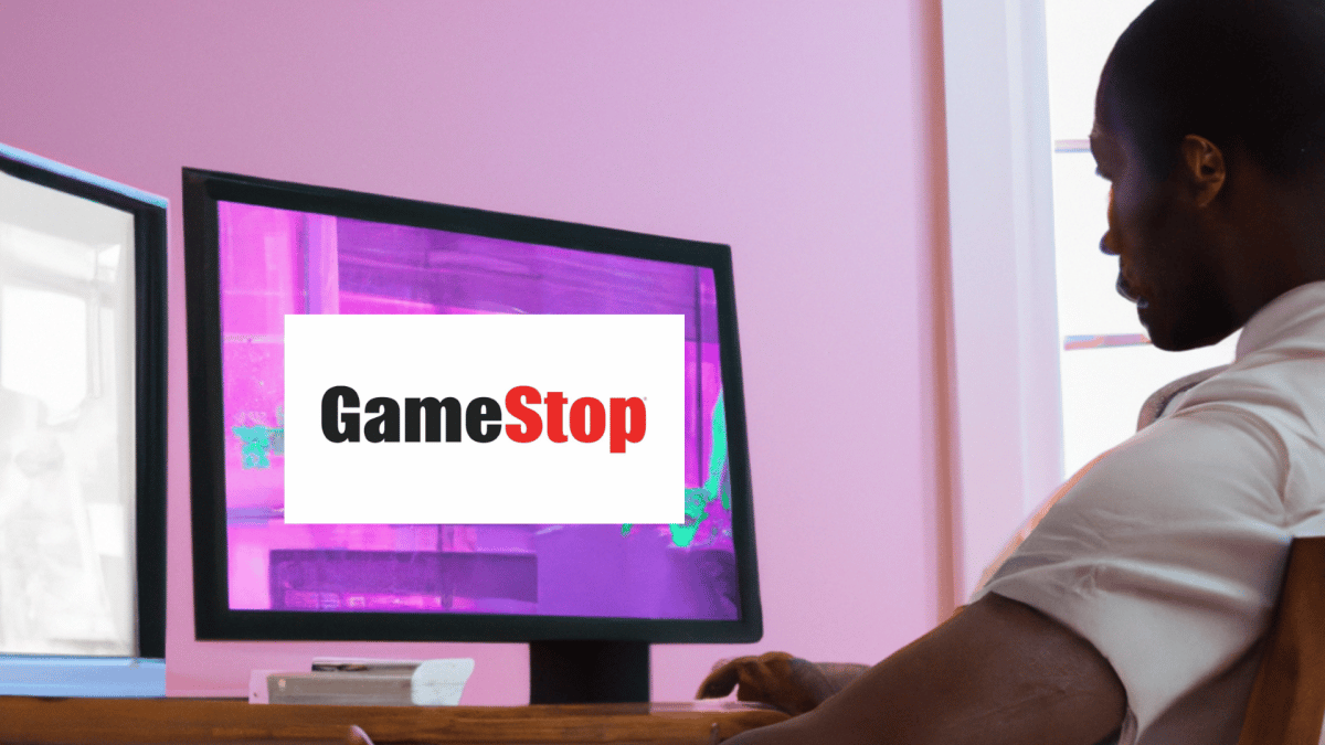 An image of a man browsing the Gamestop website while sitting in front of the computer