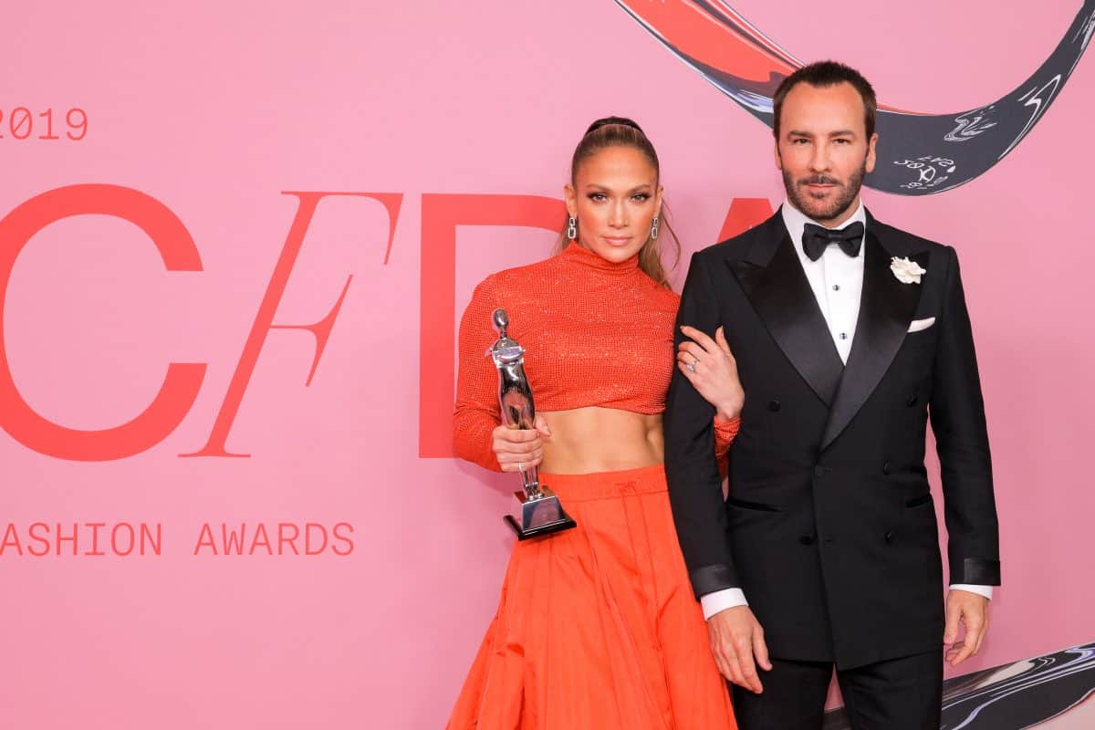 Jennifer Lopez and Ben Affleck stand on a runway. It's for the CFDA NFT Collection to celebrate it's 60th year.