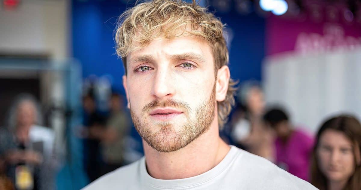 The Logan Paul CryptoZoo controversy continues, with an image showing Paul in a white t-shirt.