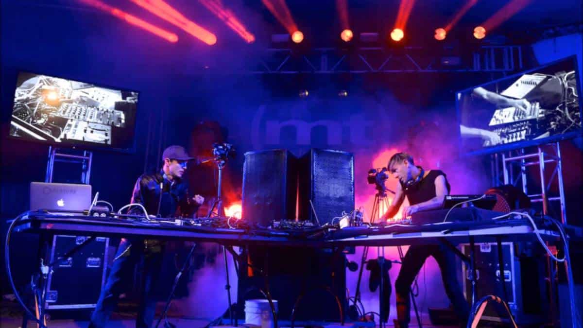 Deadmau5 and Richie Hawtin play a set together on a stage.