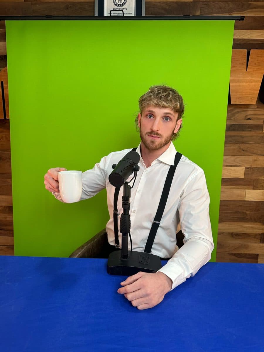 Logan Paul next to a mic and green screen