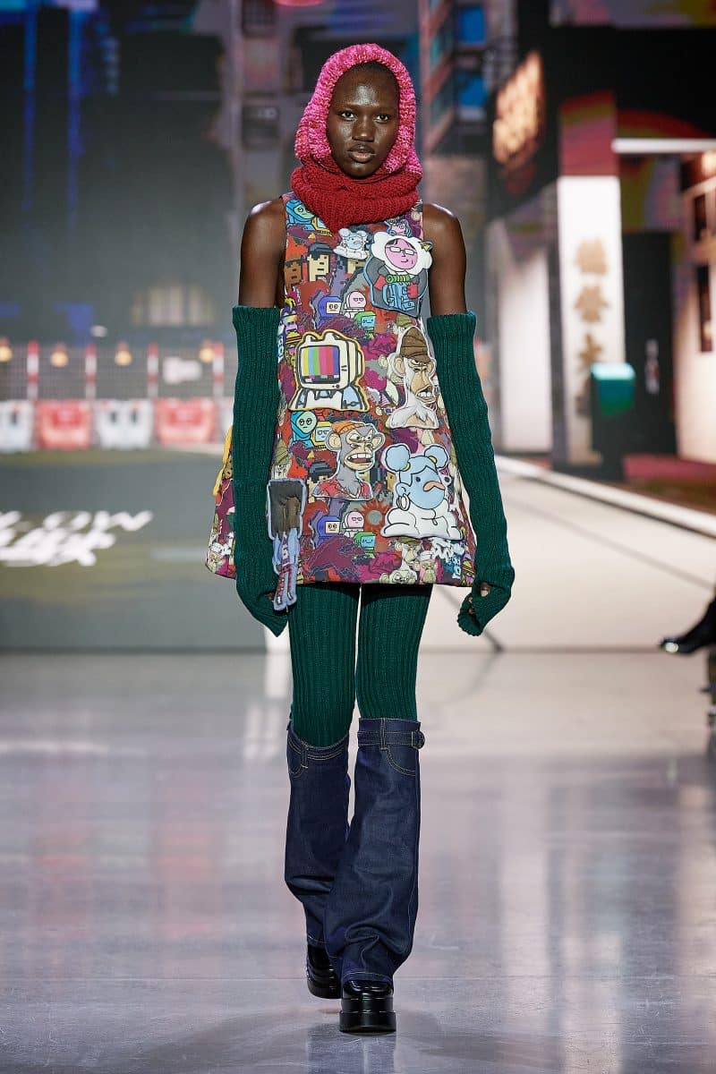 image of a runway model wearing an outfit by Vivienne Tam covered in NFT pops