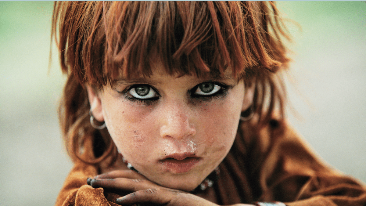 a picture of a young girl with green eyes staring into the camera, from the debut photo NFT collection by REZA