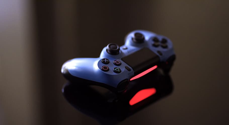 a Playstation 4 controller blinking red, the company plans to launch NFT trading systems soon