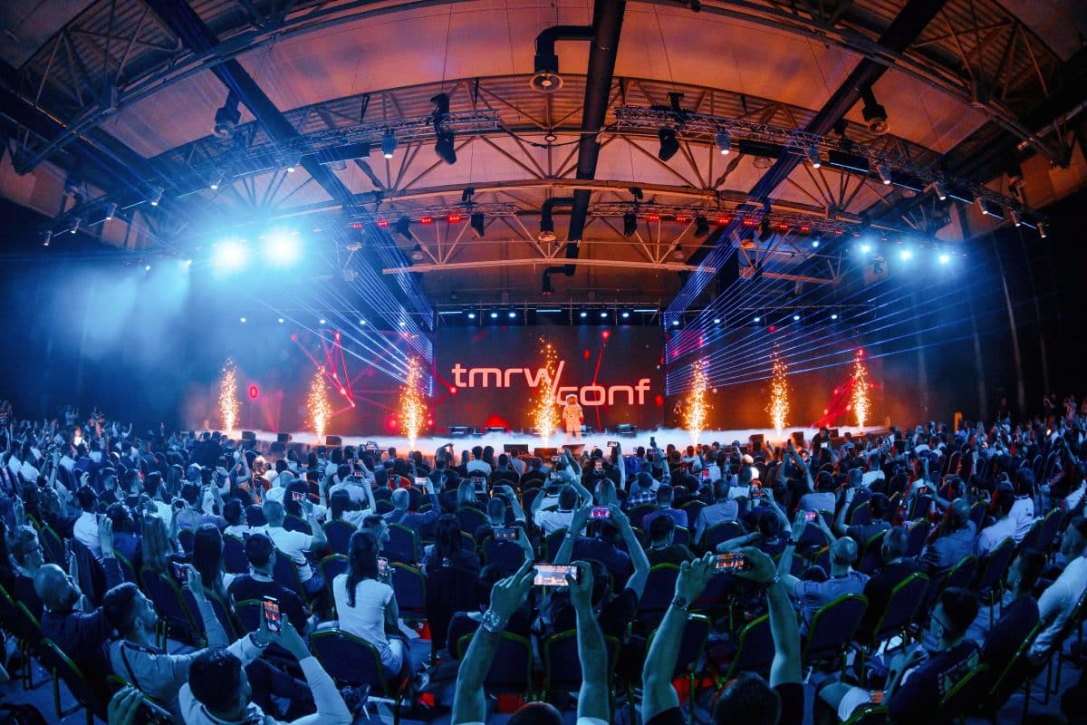 image of a stage with many attendees at the TMWR conference