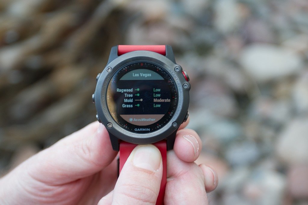picture of a person holding a Garmin Connect integrated smartwatch