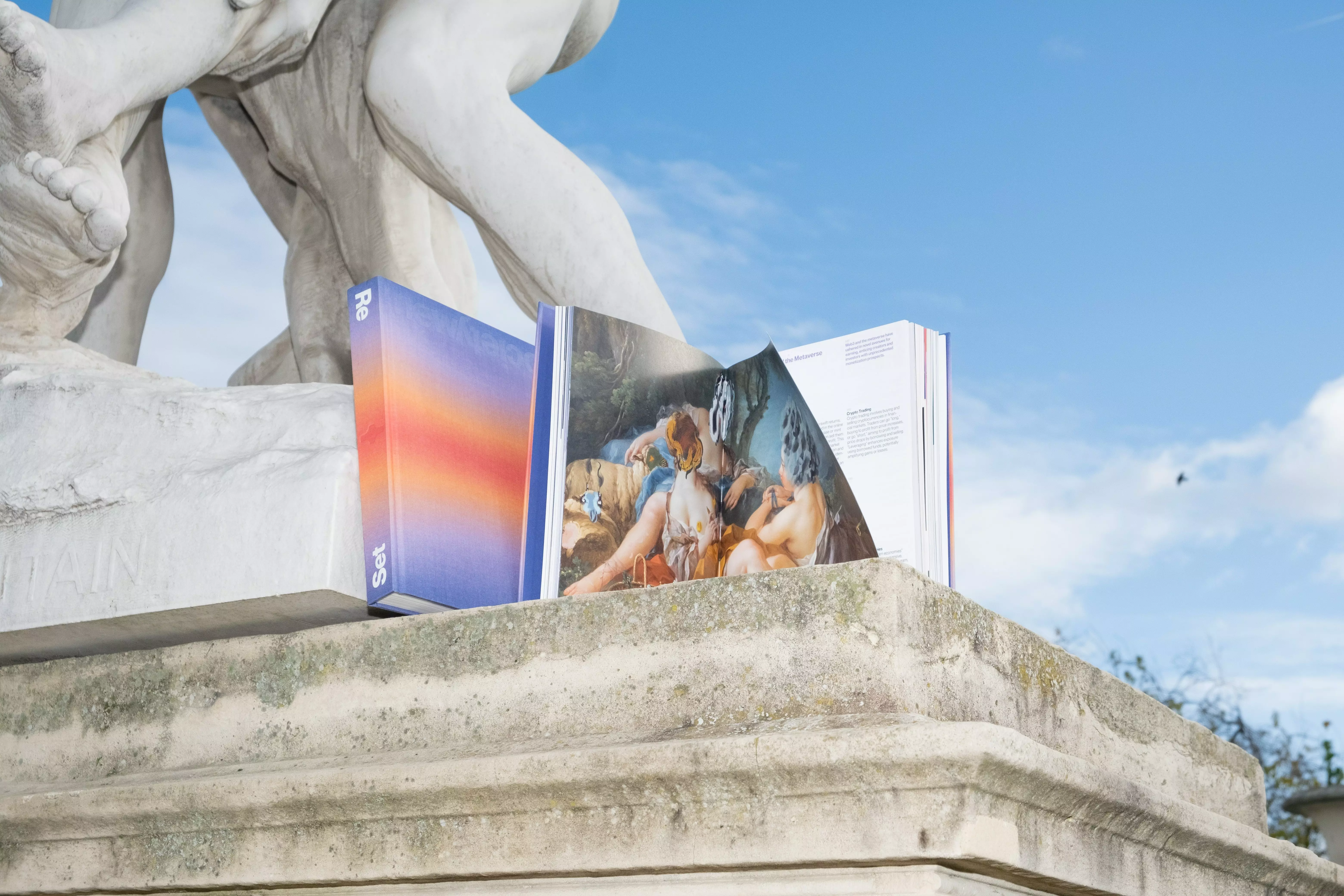 An incredible photograph of the New Society book in a stylized manner under a statue